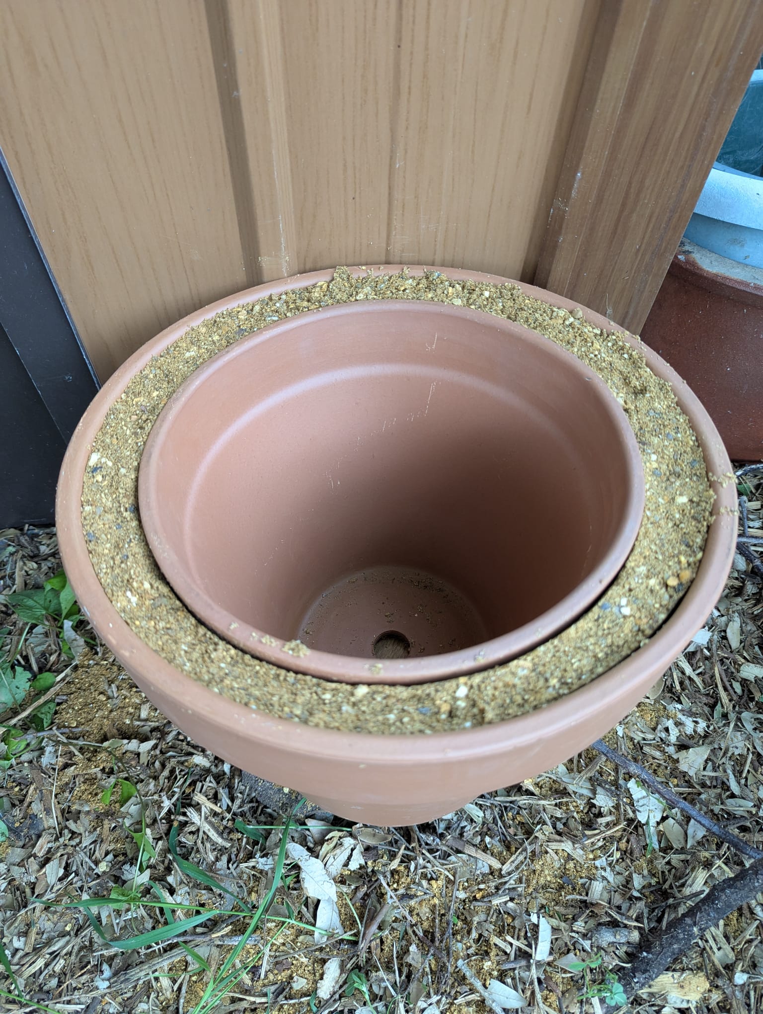 Nested terracotta pots with sand packed between them